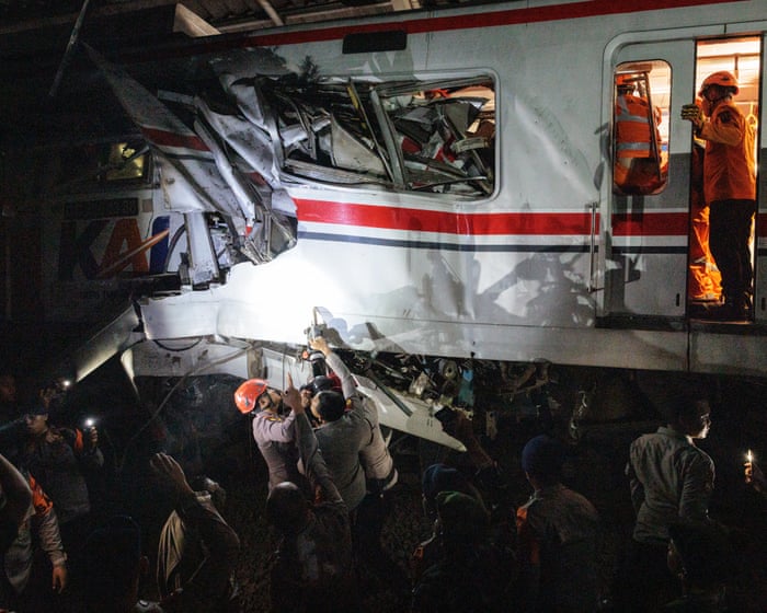 Train collision in Indonesia kills seven as rescuers work to reach survivors