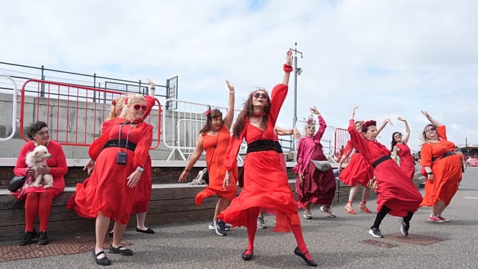 Hundreds dressed in red recreate Kate Bush’s Wuthering Heights dance