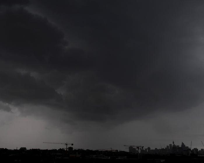 Australia news live: woman dead in powerful storm as landslide and flood warnings issued for Sydney