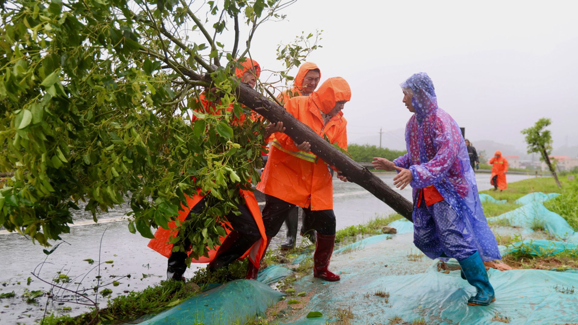 At least 10 killed as flash floods and typhoon hit China
